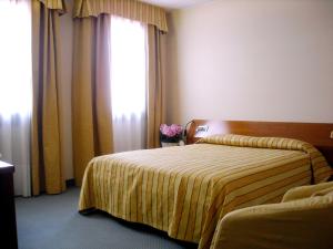Postel nebo postele na pokoji v ubytování Hotel Villa Monica