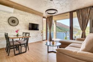 a living room with a couch and a table at Apartmani Nikic Tivat in Tivat