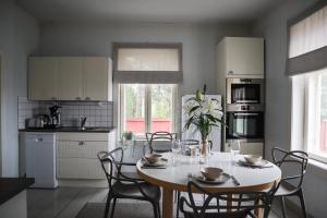a kitchen with a table and chairs in a kitchen at Kultaranta Resort in Naantali