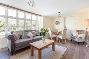 a living room with a couch and a table at Cosy 2 bed with parking and garden in Cawston