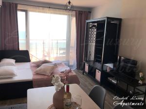 a living room with a couch and a table at Beachfront Luxury Apartments Elizabeth, Pomorie in Pomorie