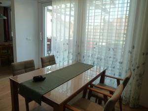 a dining room table and chairs with a large window at GOME in Meßkirch