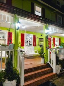 a front porch of a yellow house with stairs at Madie's Place Bed & Breakfast in Santa Rosa, Laguna near Enchanted Kingdom in Santa Rosa