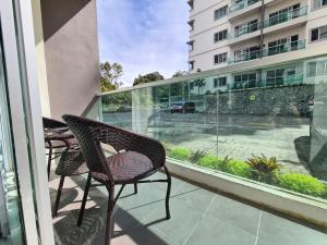 a balcony with a chair and a view of a street at The Simplicity Homestay in Tanah Rata