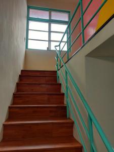 a staircase in a building with a window at 老宅小巷6人包棟民宿 in Taitung City