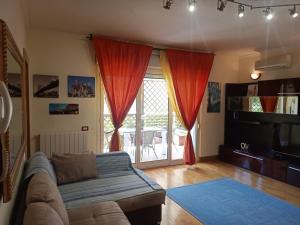 a living room with a couch and a large window at Altamira 2000 by GABRIELLA in Rome