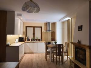 a kitchen and dining room with a table and chairs at Rowy, Słoneczne plaże in Rowy