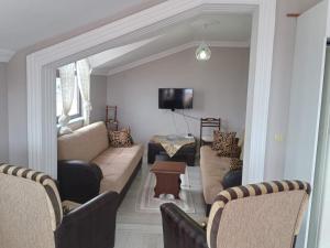 a living room with a couch and a tv at Guest House in Trabzon