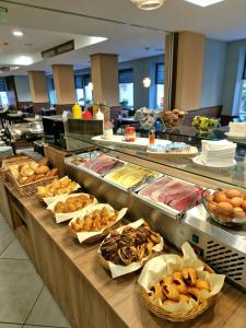 a buffet line with many different types of food at Medos Hotel in Budapest