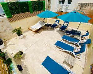 an overhead view of a patio with chairs and umbrellas at The Maltese Sun in Sliema