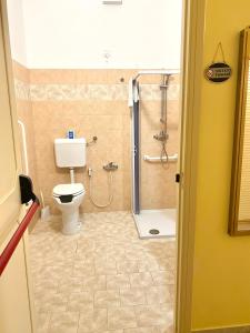 a bathroom with a shower with a toilet and a sink at OSTELLO MADRE SANTINA in Lecce