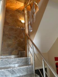 a staircase in a house with a stone wall at Andrea House in Berat