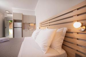 a bedroom with a large bed with white pillows at Casa Maresol in Nea Skioni