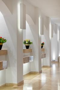 a hallway with flower pots on the wall at Marti Resort Deluxe Hotel in Marmaris