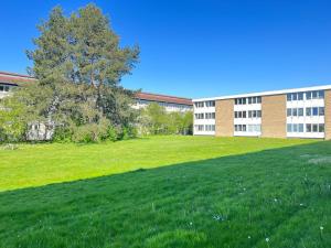 a large grassy field in front of a building at Two Bedroom Apartment In Rdovre, Trnvej 37b, in Rødovre