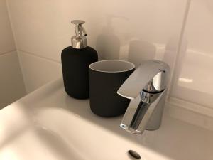 a bathroom sink with a soap dispenser on it at "Seeblick und mehr" in Millstatt