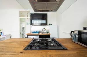 a kitchen with a stove top oven next to a microwave at Hyde Park Apartments in London
