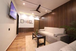 a living room with a couch and a flat screen tv at Perfectstayz Homes I Luxury Penthouse in Haridwār