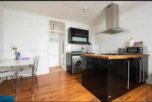 a kitchen with a counter top and a stove top oven at Hyde Park Apartments in London