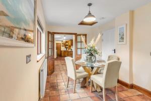 a dining room with a table and chairs at The Woodrow Cottage in Cawston