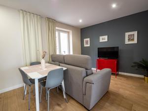 a living room with a couch and a table at Apartantiguo San Isidoro10 in Oviedo