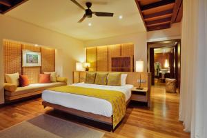 a bedroom with a large bed and a couch at Le Jadis Beach Resort & Wellness - Managed by Banyan Tree Hotels & Resorts in Balaclava