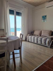 a bedroom with a bed and a table and a table and chairs at APARTMANI TONI POCE 2 in Primošten