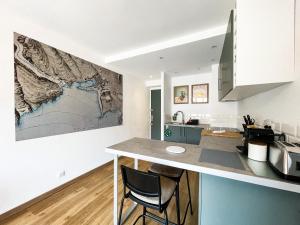 a kitchen with a large map on the wall at Le Pagnol - Hyper centre - Clim in Cassis