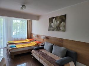 a living room with two beds and a couch at Apartamenty Planeta 105, 108 Mielno in Mielno