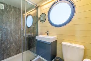 a bathroom with a toilet and a sink and a shower at Laburnum Farm Estate in Alderton