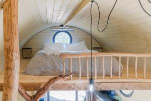 a bed in the middle of a room at Laburnum Farm Estate in Alderton