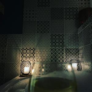 a bathroom with a tub with two lights in it at Relaxing Riverside Cottage in Llangwm