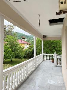 a white balcony with a view of a house at Guest House In Gonio in Gonio