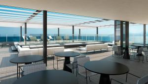 a balcony with tables and chairs and the ocean at BG Tonga Tower in Can Picafort