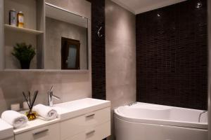 a bathroom with a sink and a tub and a toilet at 4 TRAVELERS Together in Thessaloniki +33 photos
