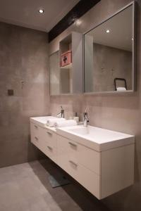 a bathroom with a white sink and a mirror at 4 TRAVELERS Together in Thessaloniki