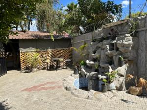 a garden with a fountain in a yard at Mabelajoy Palmgarden BnB in Nakuru