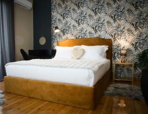 a bedroom with a large bed with white pillows at 4 TRAVELERS Together in Thessaloniki