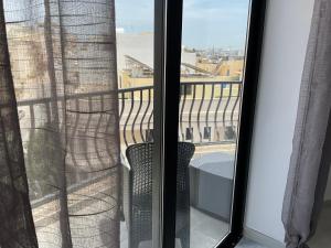 a view from the balcony of a room with a window at Privilege suits Swatar in Birkirkara