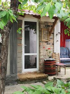 a door of a house with a chair and a barrel at Authentic apartment in the centre in Chişinău