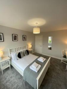 a bedroom with a bed with two tables and two lamps at Storey Apartment in Woodhorn