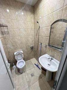 a bathroom with a sink and a toilet and a mirror at Guest House In Gonio in Gonio