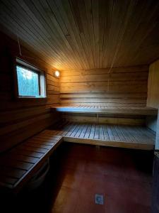 a inside of a wooden cabin with a window at Country side/Kaštonų alėja - Sodyba in Sudeikiai