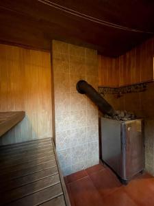 a room with a pipe hanging on the wall at Country side/Kaštonų alėja - Sodyba in Sudeikiai