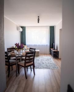 a living room with a dining room table and chairs at Cozy apartment in the city center of Kärdla in Kärdla