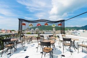 eine Terrasse mit Tischen und Stühlen auf einem Balkon in der Unterkunft Grand Villa Residence Vũng Tàu in Vũng Tàu