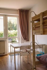 a room with a table and chairs and a loft bed at Girls Willa in Kraków