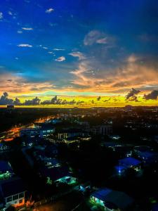 a view of a city with a sunset in the sky at ITCC Manhattan Suites by LAVISH in Kota Kinabalu