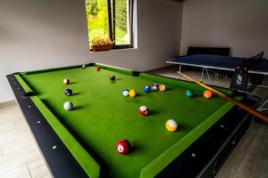 a pool table with balls on top of it at Pensiunea Romconcord in Bălceşti +21 photos