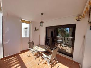 uma sala de jantar com mesa e cadeiras e uma varanda em Azahar em Alicante